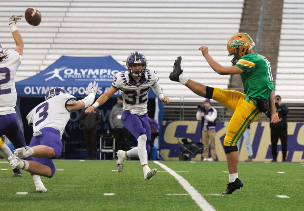 Anacortes' Brady Beaner, left, get a hand to block a punt by Tumwater.