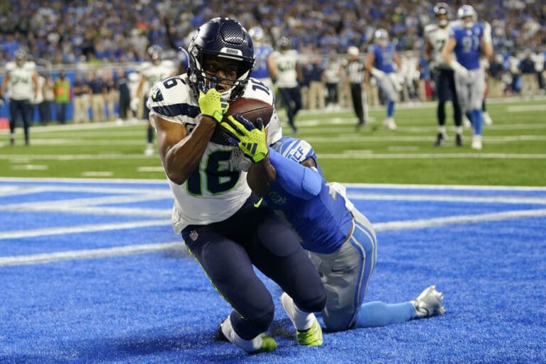 Seattle Seahawks wide receiver Tyler Lockett (16) catches a 3-yard touchdown pass as he gets tackled just as he catches the ball.