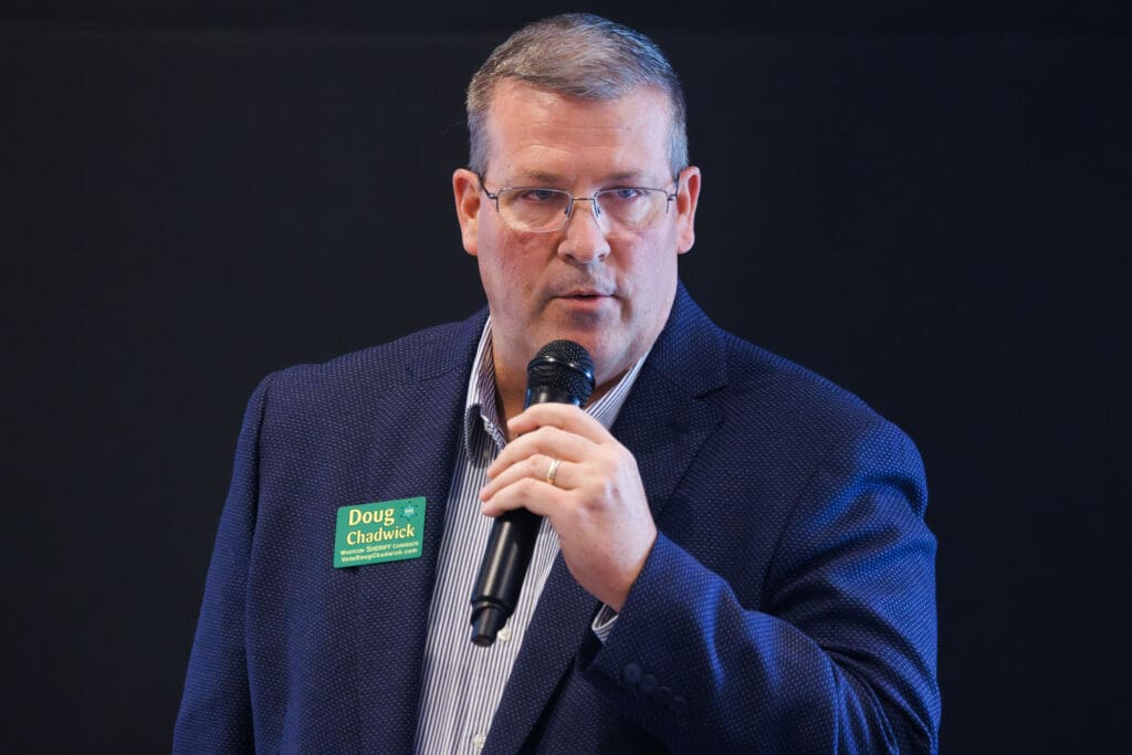 Whatcom County sheriff candidate Doug Chadwick speaks into a mic.