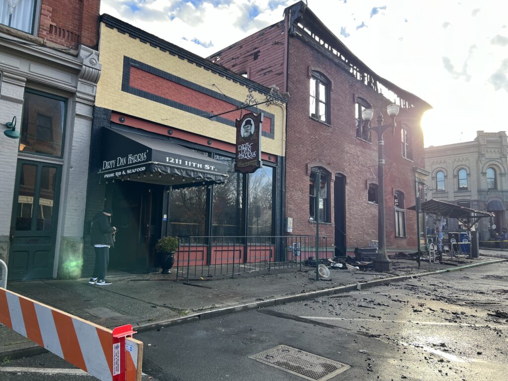 The sidewalk of Dirty Dan Harris restaurant is littered with trash and ash.