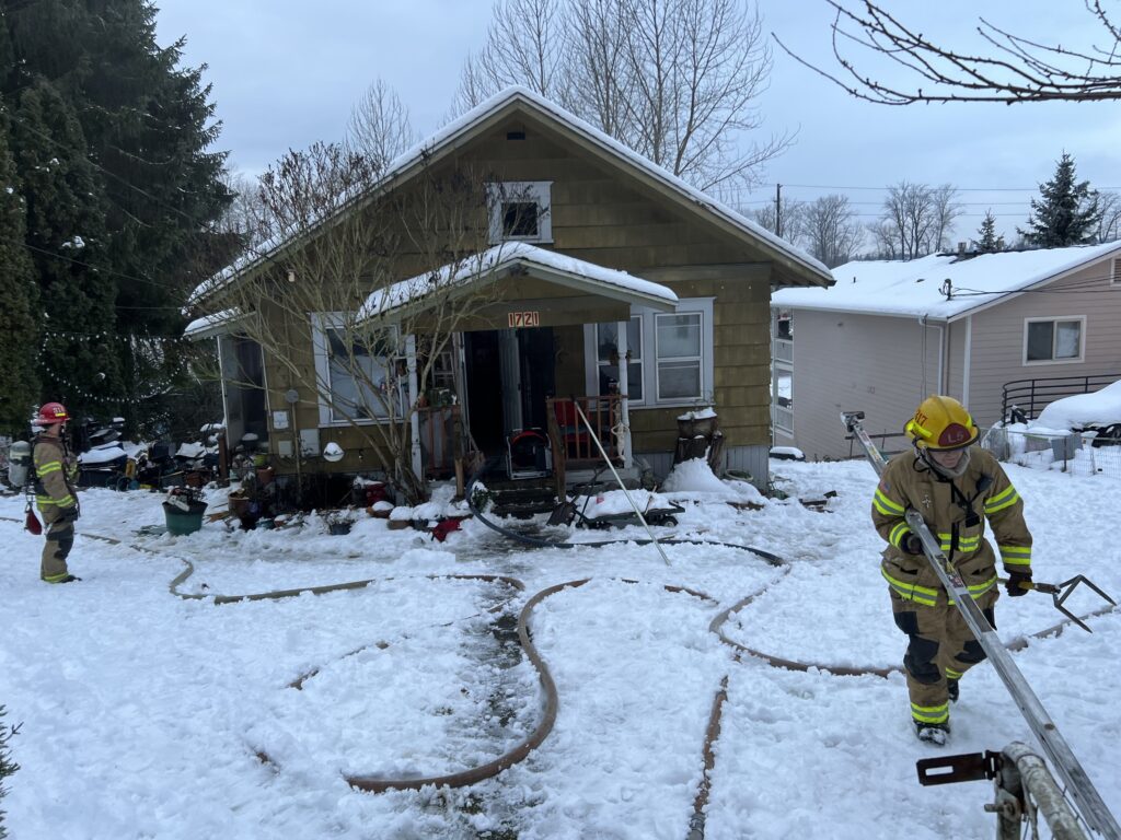 Bellingham firefighters clearing the scene after extinguishing the fire in a residential house.