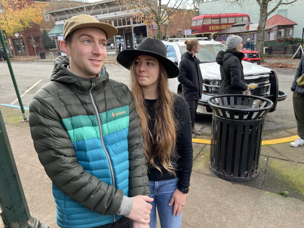 Sam Sigl, left, and Sienna Templeton visited the scene Sunday morning, they are standing on the sidewalk near other groups of onlookers.