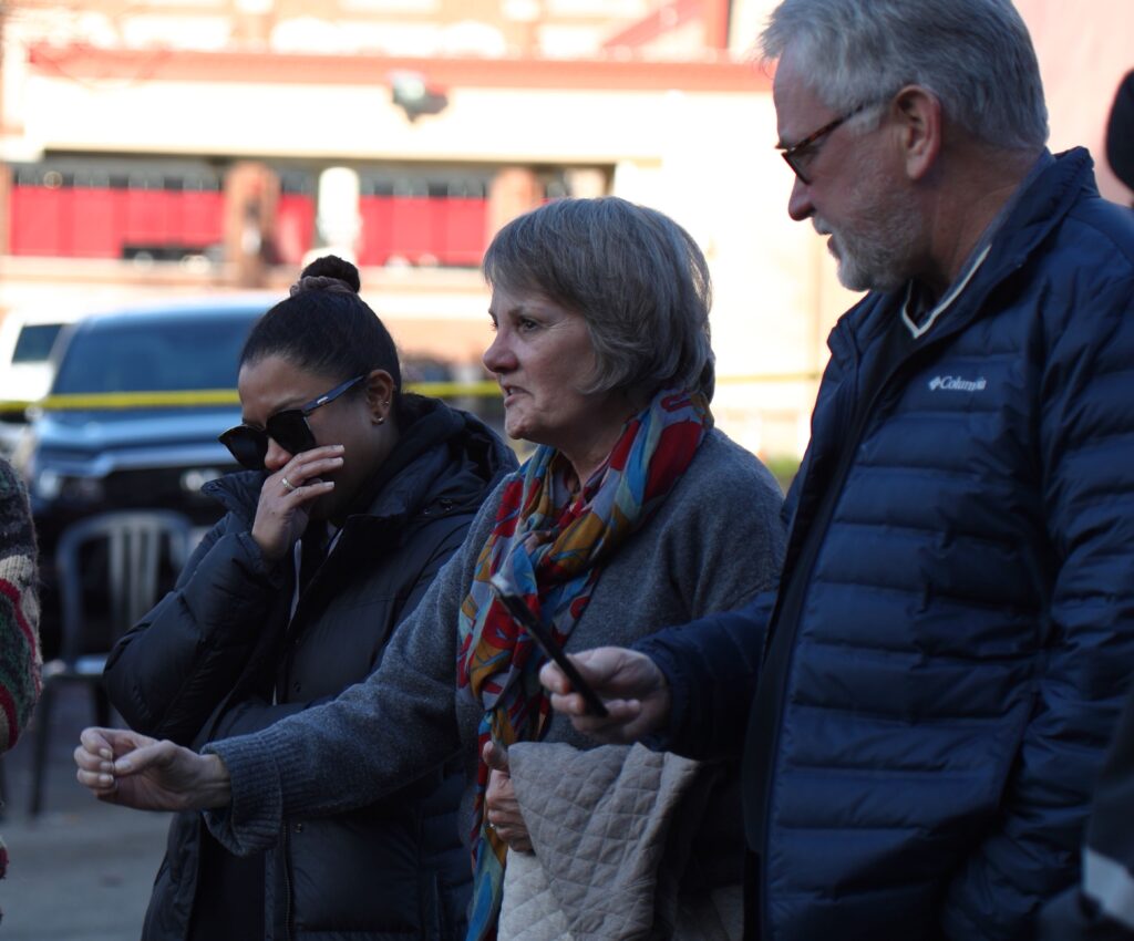 Nate Breaux’s parents, Belinda, center, and Randy, right, speak about their lost son shortly after a body was recovered from the Terminal Building.