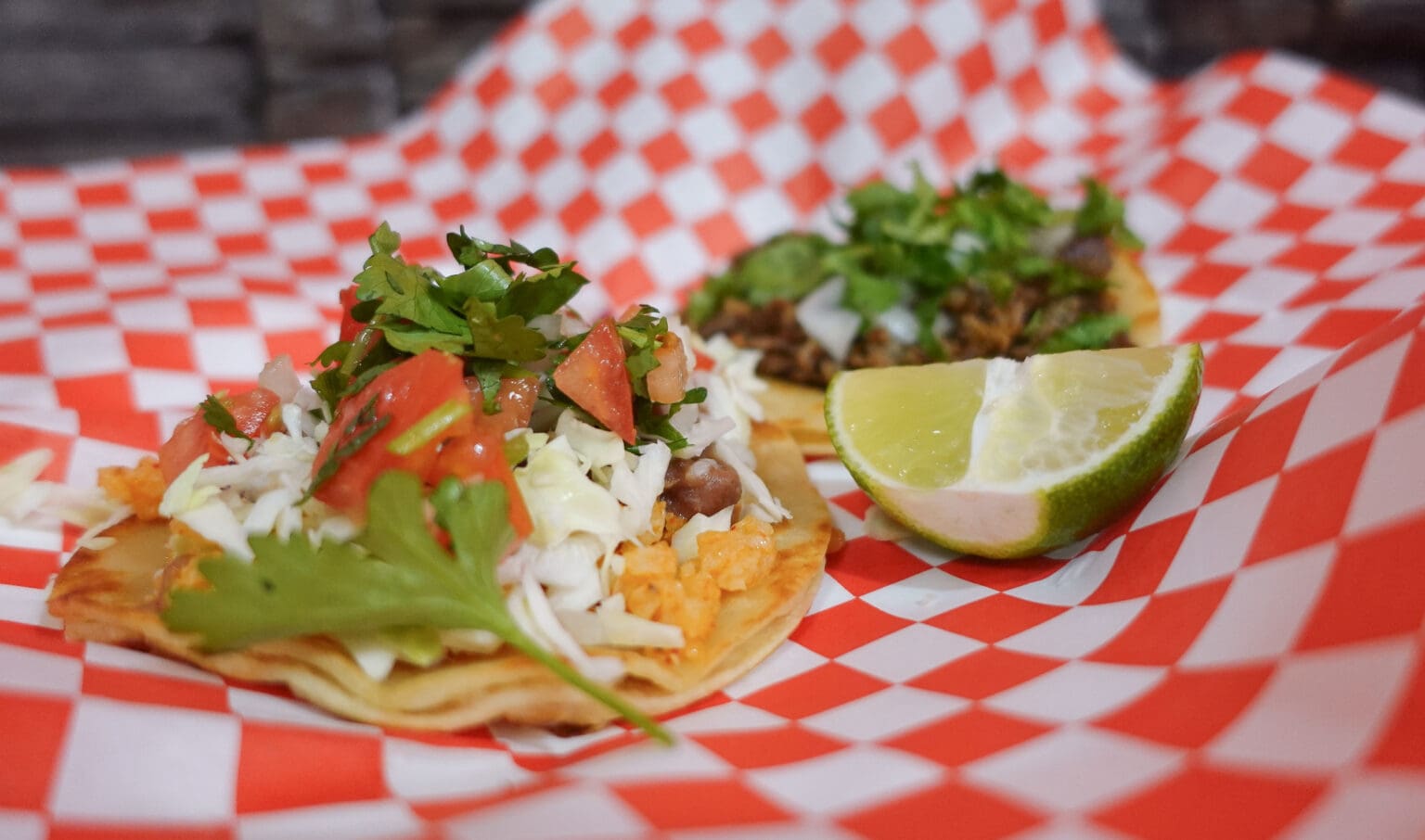 Tecalitan Mexican Restaurant's veggie tacos served on a checkered paper.