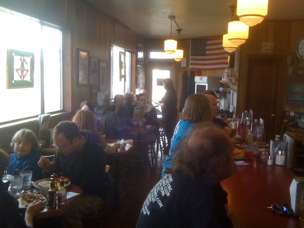 Sheryl Johnson takes orders at the old Diamond Jim's Grill at full capacity customers eat with their family and friends.