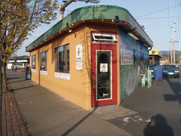 The triangular building housing the first locale of Diamond Jim's Grill has its entrance on the corner of the building.