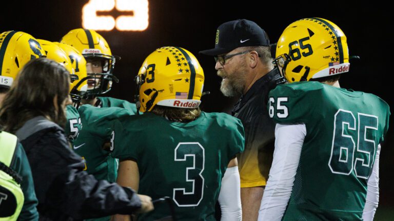 Sehome High School head football coach Kevin Beason surrounded by his team.