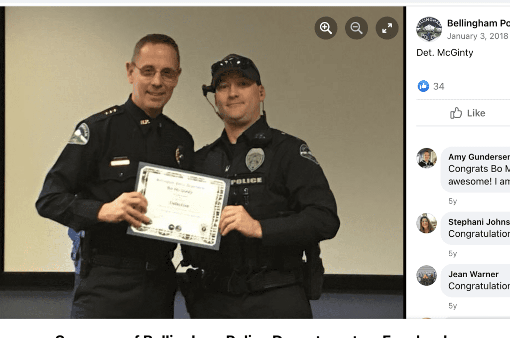 A social media site post of two cops holding a certificate between them.