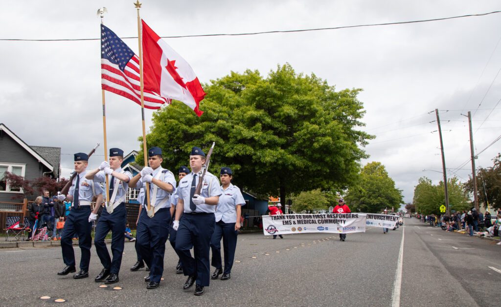 A color guard leads the Whatcom Memorial Day Parade down Cornwall Avenue on Saturday, May 25 with U.S. and Canadian flags.