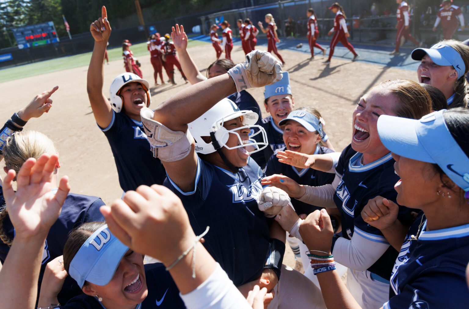 Western Washington University's Maleah Andrews is lifted by her teammate after her walk-off solo home run won game three of the Super Regional series against Cal State Dominguez Hills Wednesday, May 15. The win means the Vikings head to the Elite Eight for the first time in program history.