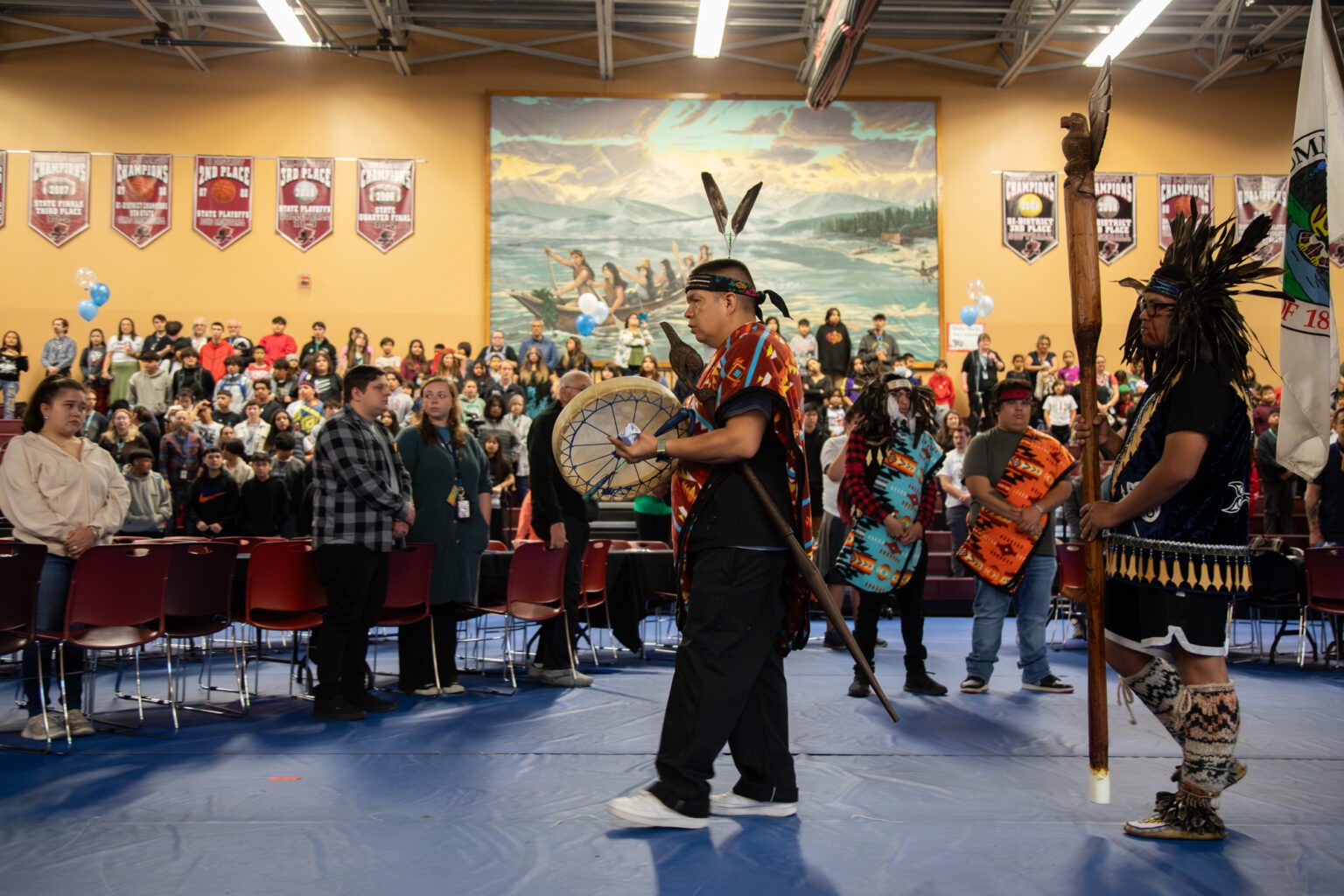 Lawrence Solomon, Lummi Nation School's Curriculum Immersion Director, leads the flag procession of veterans at the start of the ceremony.