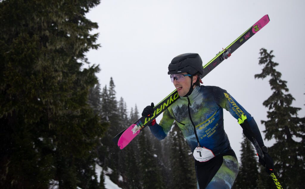 Aidan Crawford, of team Pavlov’s Dawgs, climbs with his skis.