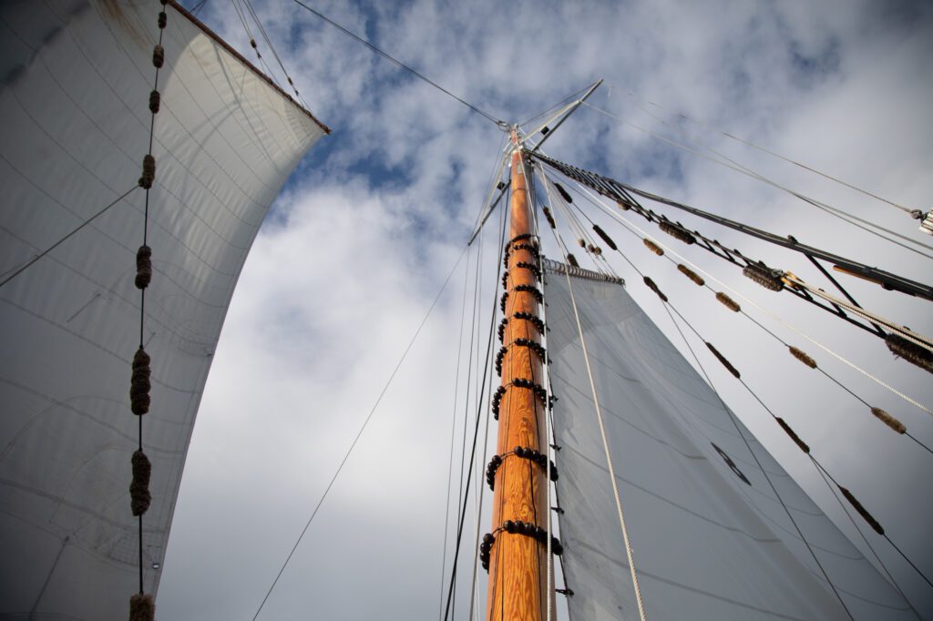 Blue sky peaks through the clouds above the schooner Zodiac.