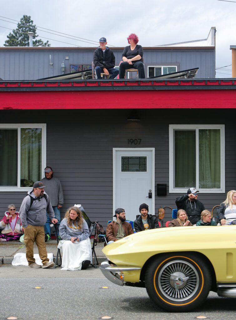 Parade-goers watch Corvettes from the Corvettes Unlimited of Bellingham club.