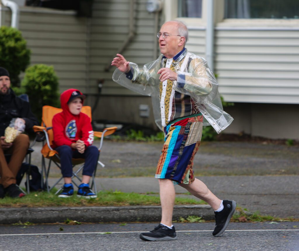 Mark Allyn dances alongside the parade.