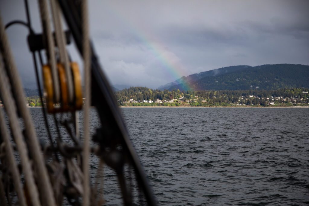 A rainbow erupts from just south of Fairhaven.