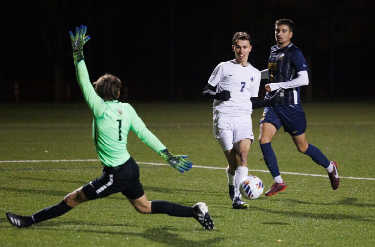 Western Washington University’s Albin Jonsson (7) is about to kick the ball as the goalie extends his limbs to block the shot.