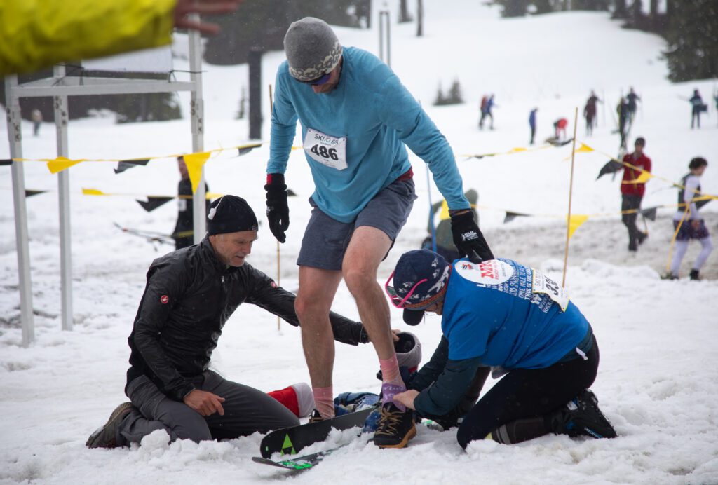 Dave Schruth, of team FasterBakers, swaps from downhill skis to running shoes for his second leg of the race. He finished the two legs in just under 77 minutes.