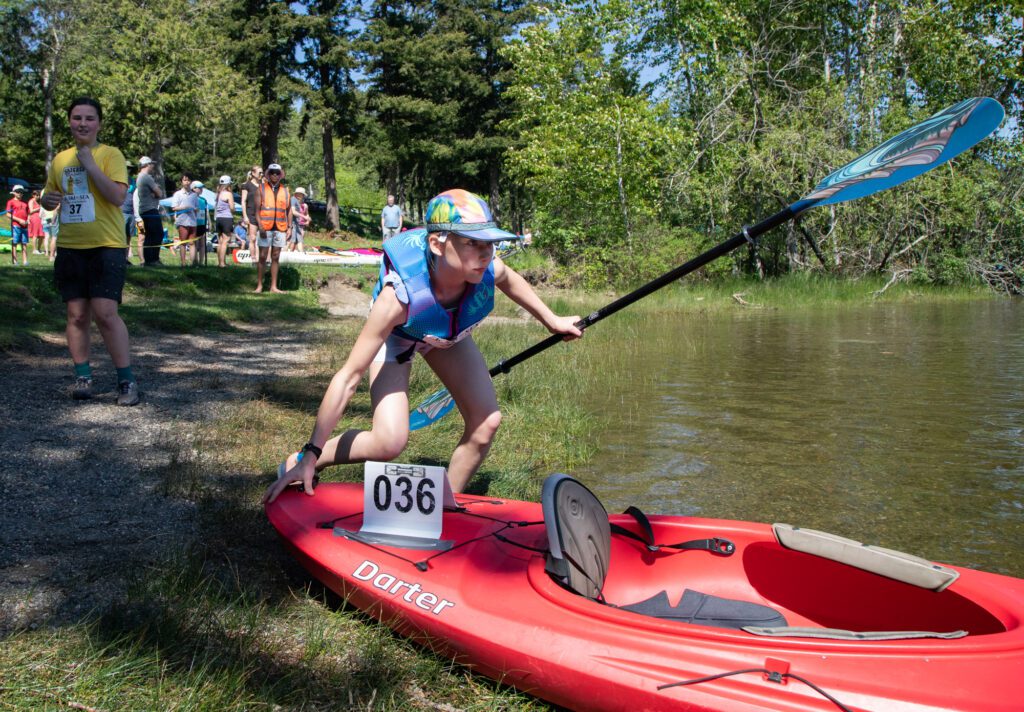 Melina Peterson of Calm Be-Four the Storm launches her kayak for the final leg.