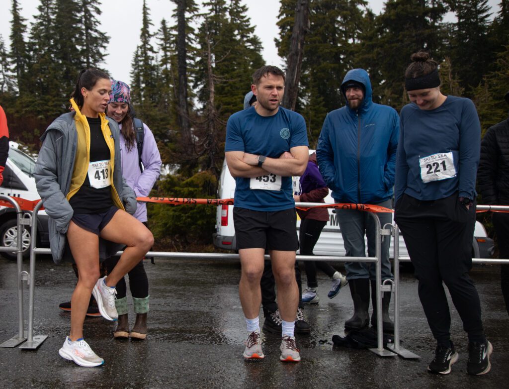 From left, Kelly Hayden of Reverse Ski Girl, John Chambers of DARKHORSE and Libby Kokes of Data-Driven Downhillers try to stay warm while waiting for skiers to arrive.