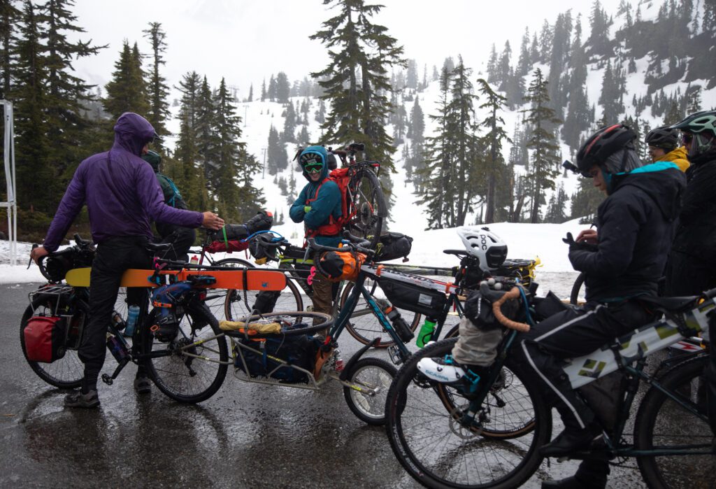 The car-free teams wait to descend down Mount Baker Highway after all the runners left on bikes packed with gear.