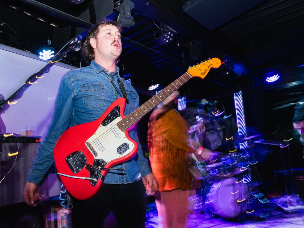 Smooth Kiwi guitarist Tanner Small lets loose after the song concludes at the Blue Room. The band wore western themed clothes.