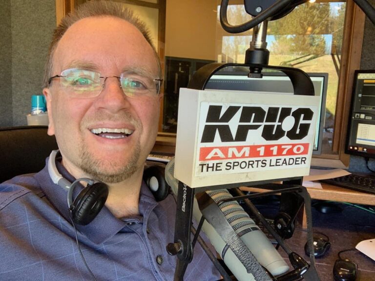 Whatcom County sportscaster Mark Scholten taking a selfie while next to the radio microphone for KPUG.