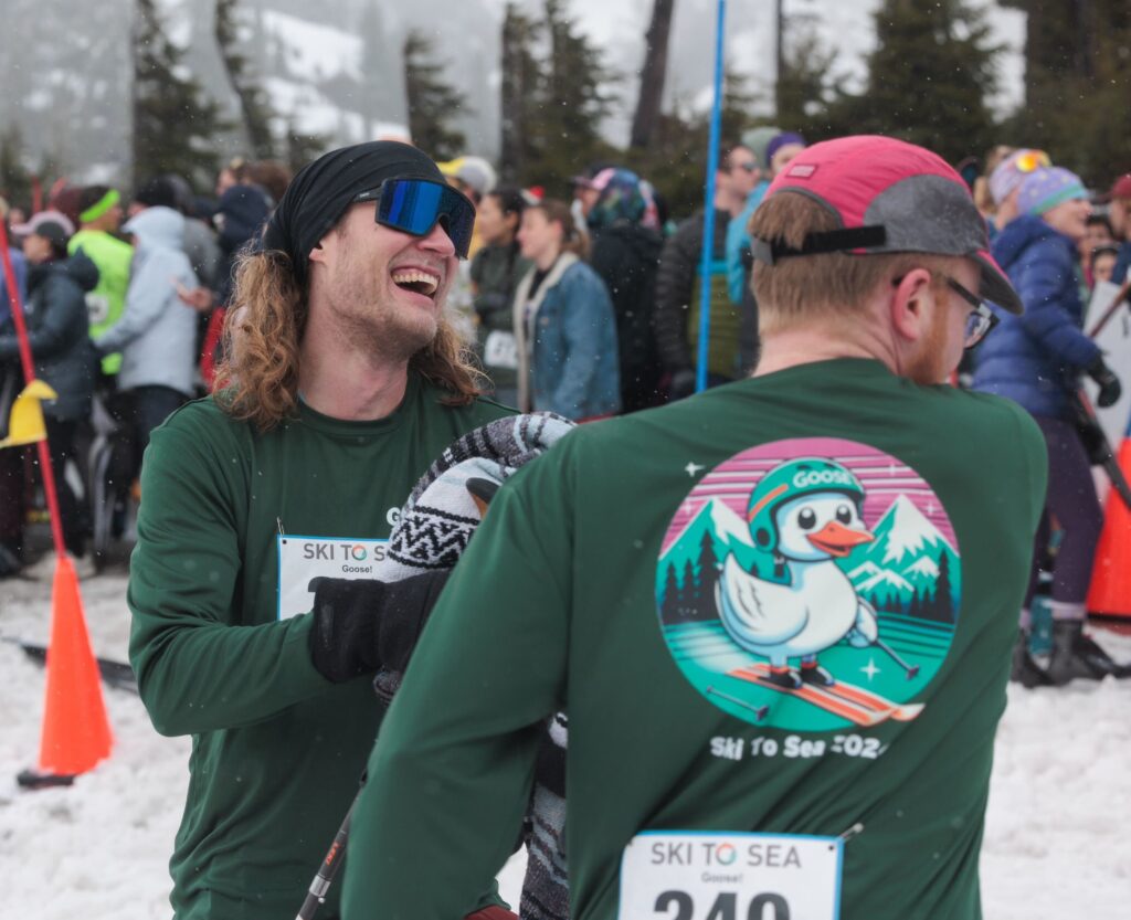 Michael Jedynak of team Goose! laughs while trading the timing chip for a blanket from teammate Connor Dickson.