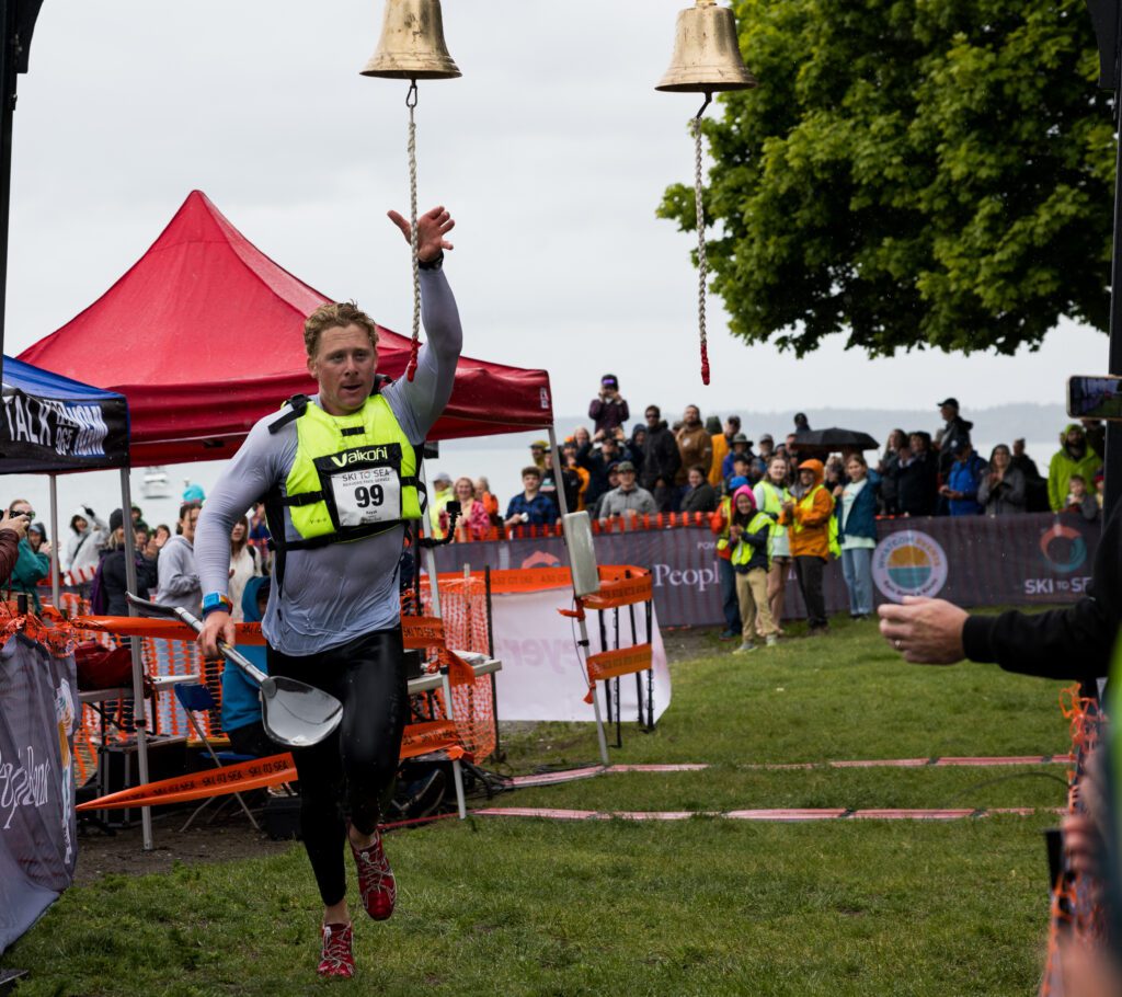 Jonas Ecker of team Beavers Tree Service rings the bell at the finish line.