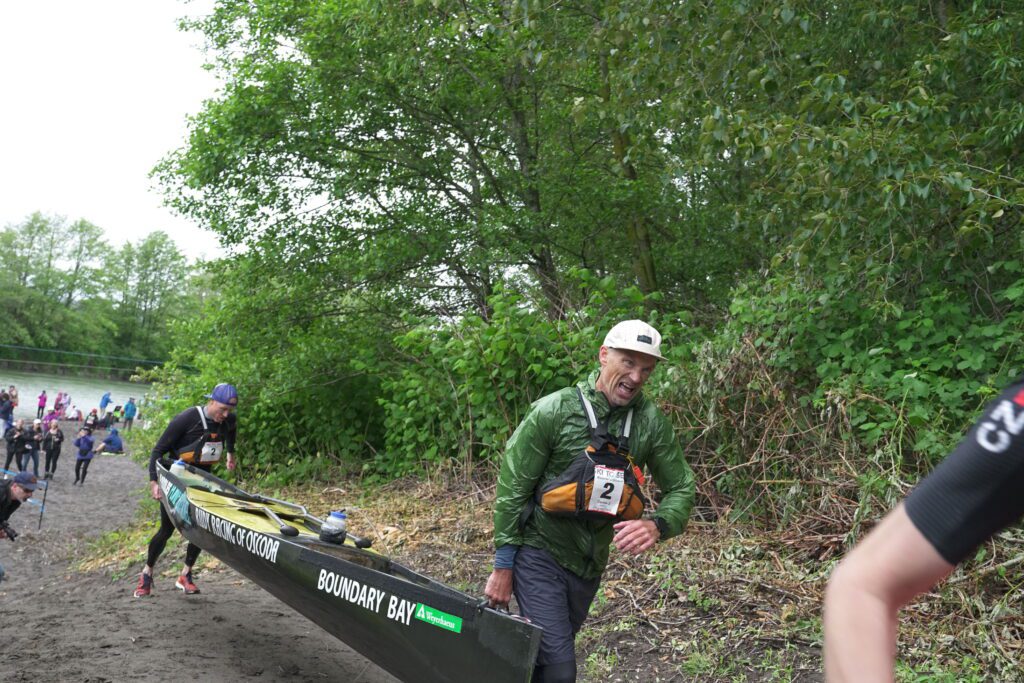 Canoeists Brad Buaer and Dave Jensen of team Boomer's Drive-In arrive at Hovander Homestead Park. They finished the leg in third place.