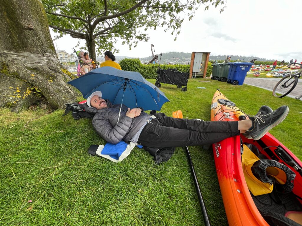 Casey Coombs, 42, of Seattle created a makeshift tent for protection from the rain while waiting to start his kayak leg at Ski to Sea. The day got a little wet as it went along.