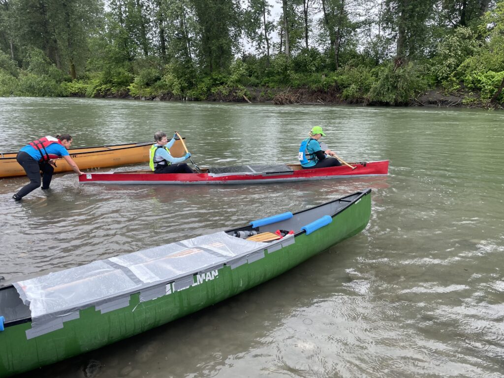 Janice Lapsansky and Jackie Caplan-Auerbach of team Zeek's Wild Combo are pushed off by a fellow racer on the Nooksack River.