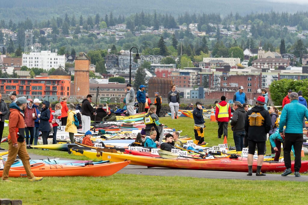 Kayakers wait for their cyclocross teammates to arrive at Zuanich Point Park to hit a zigzag course across Bellingham Bay.