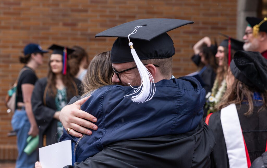 Rowan Murray hugs a supporter after graduating from Western Washington University on Saturday, June 15 at Sam Carver Gymnasium.