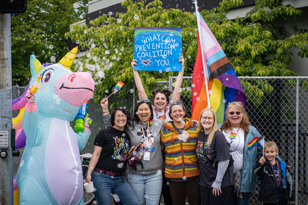 Members of the Whatcom Prevention Coalition hold signage along the parade route.