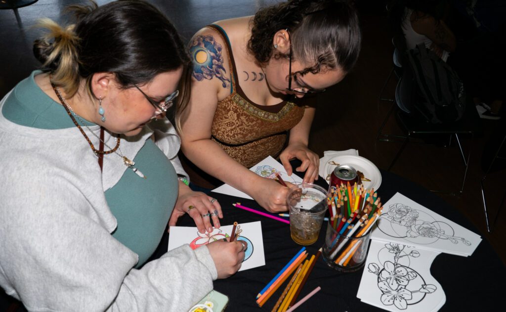 Students color in designs by artist Susan Puailiau Lindsey on Thursday, May 30 during the APIDA (Asian Pacific Islander Desi American) Art Showcase at Western Washington University.