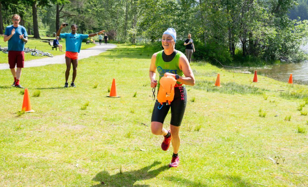 Kat Klass grins as she approaches the finish line, making her the first female finisher and third overall in the long course. Klass had competed once before in a duo and found that racing solo this time felt more like a personal challenge.