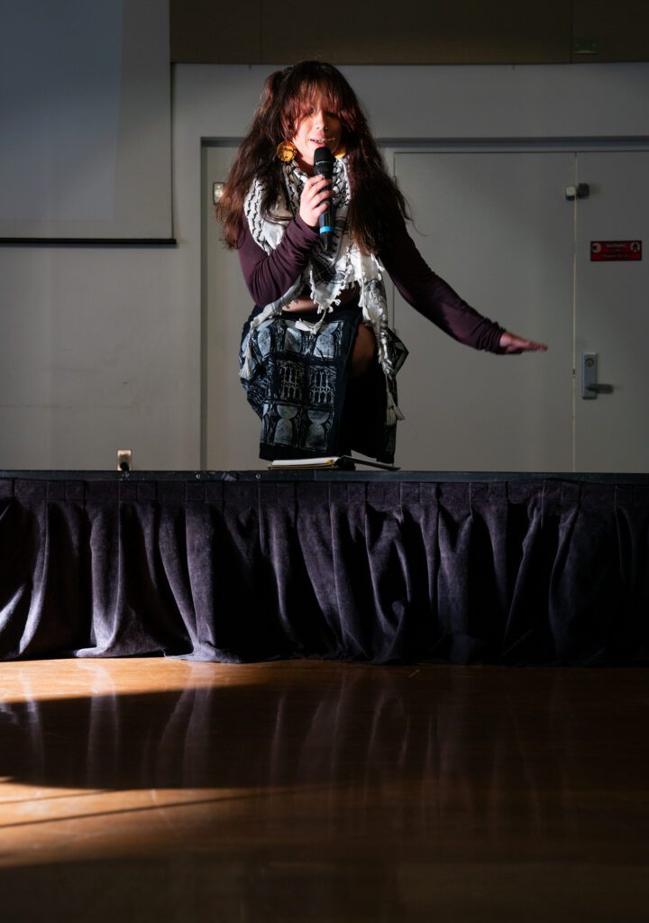 Hawaiian and Filipino artist Mer Pascual, who is the vice president of the Pacific Islander Student Association, reads their poetry. As one of the organizers of the showcase, Pascual believes the event highlighted APIDA (Asian Pacific Islander Desi American) voices in a joyous way rather than focusing on typical narratives of trauma and pain.