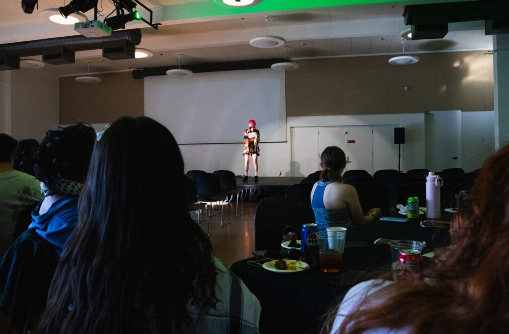 An audience, mostly composed of students, listens to Charla Anne Larson sing. While the turnout wasn't what organizers hoped for, they are excited to build on the first-time event in future years.