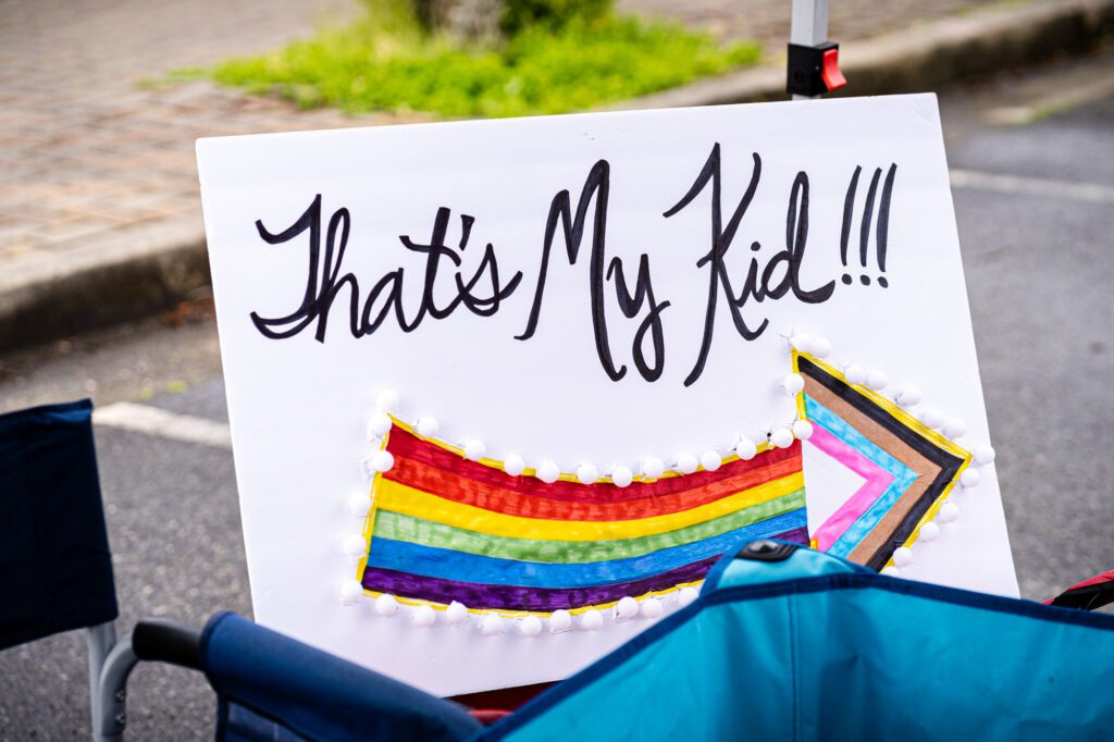 A sign reads "That's my kid!" at Whatcom Youth Pride. Many parents marched alongside their children during the event to show support.