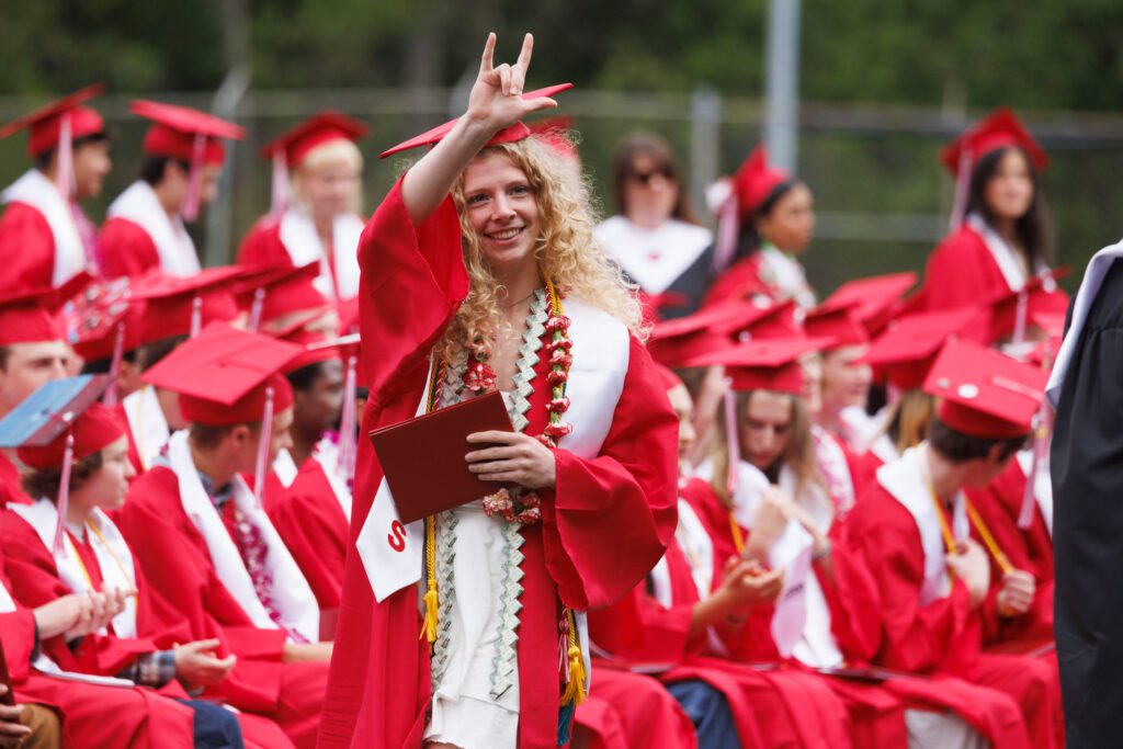 Bellingham High School graduate Opal Barker signs “I love you” after receiving her diploma Saturday, June 15 during the graduation ceremony at Civic Stadium.