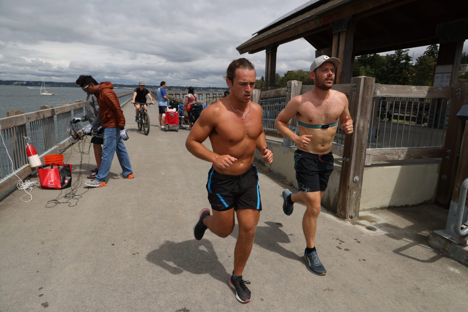 After a 110-mile bike ride, Jake Birnel, left, and Ethan Hunger continue jogging along the boardwalk.