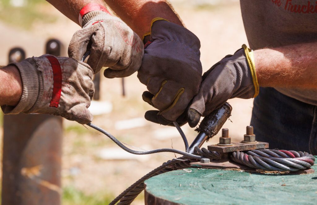 Loggers splice cable wires during competition.