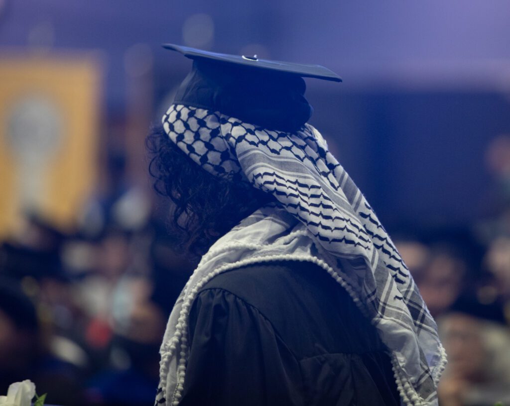 Many students donned keffiyehs and left red or white flowers on the stage in solidarity with Palestine.