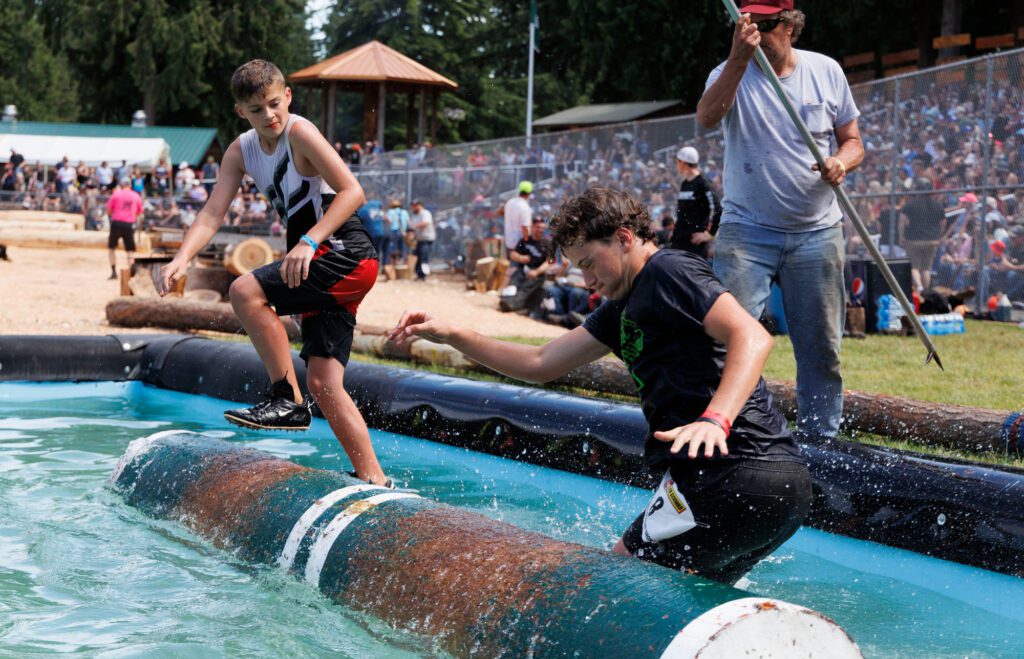 Jax Little, left, knocks off Emmett Sampson during the novice log rolling.