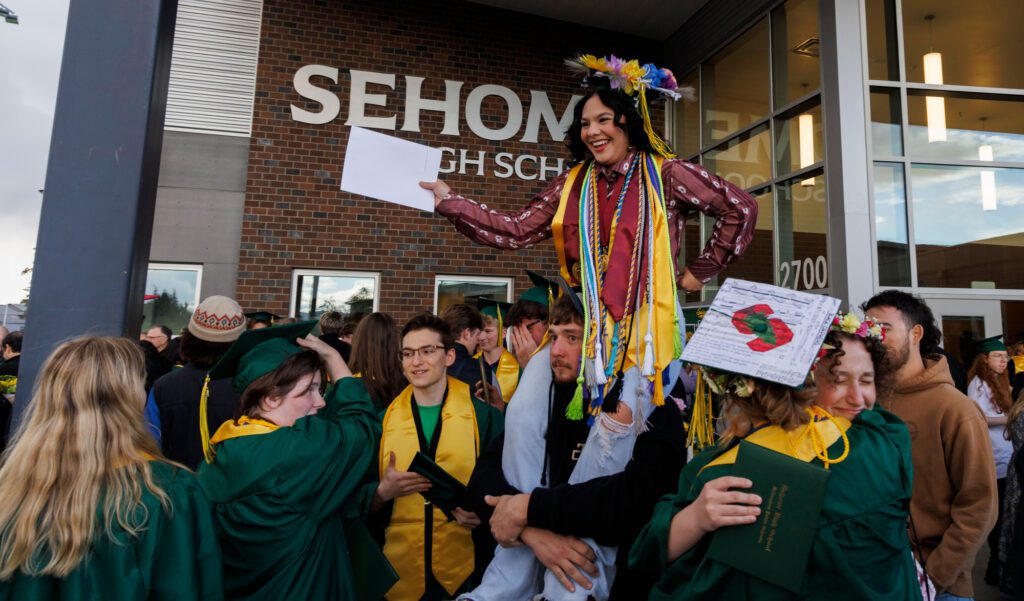 Graduate Hailey McCann-Gould is carried by her boyfriend Logan Sasken after picking up her diploma.