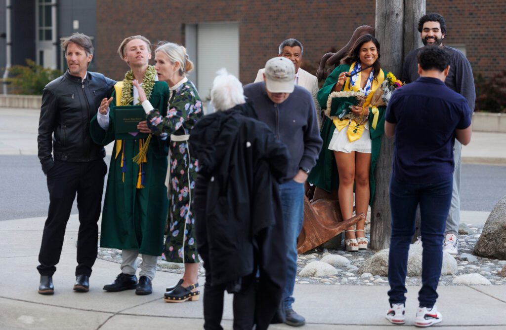 At the high school, Sehome graduates pose for photos with their families.