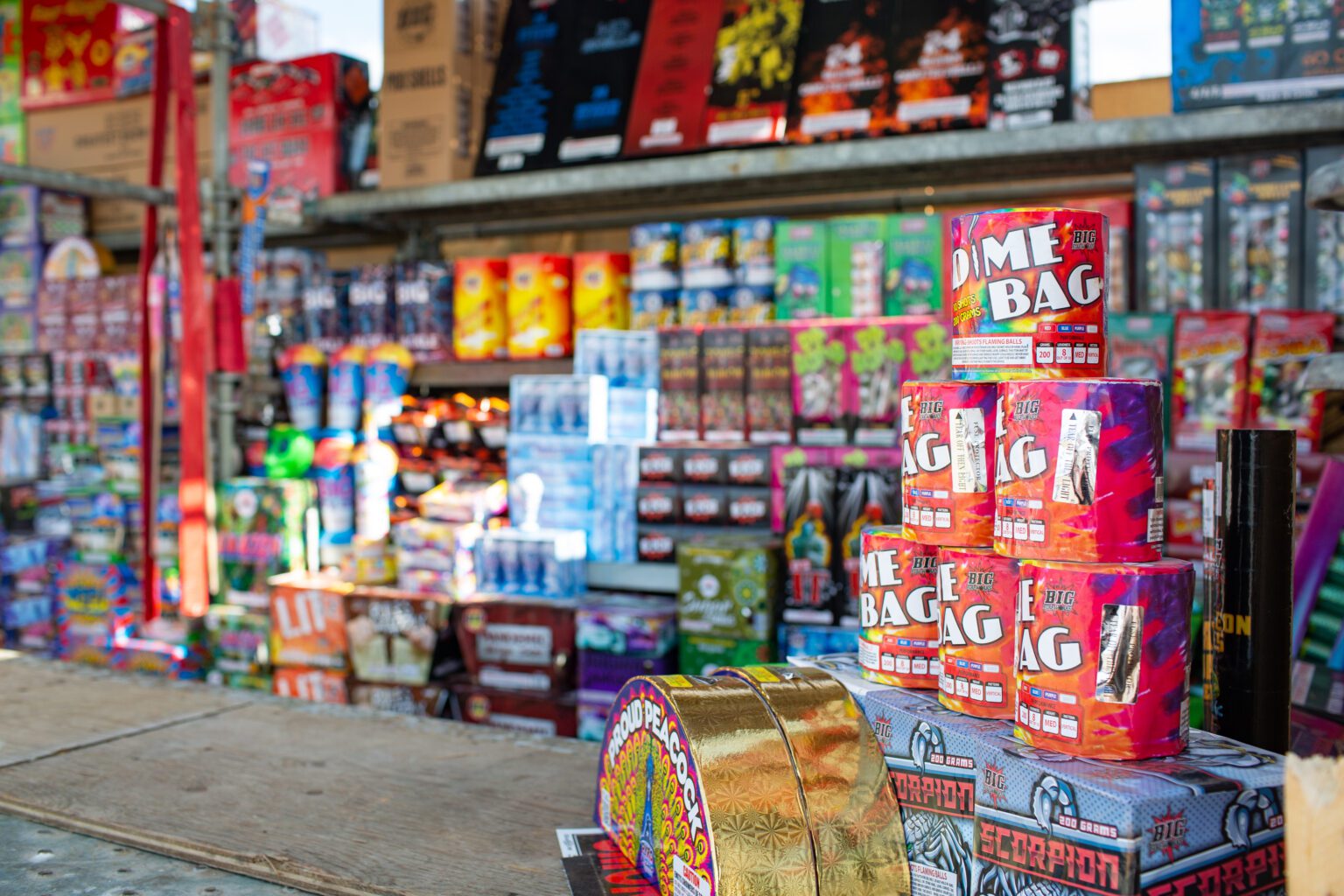 Counters and shelves full of various fireworks are on sale.