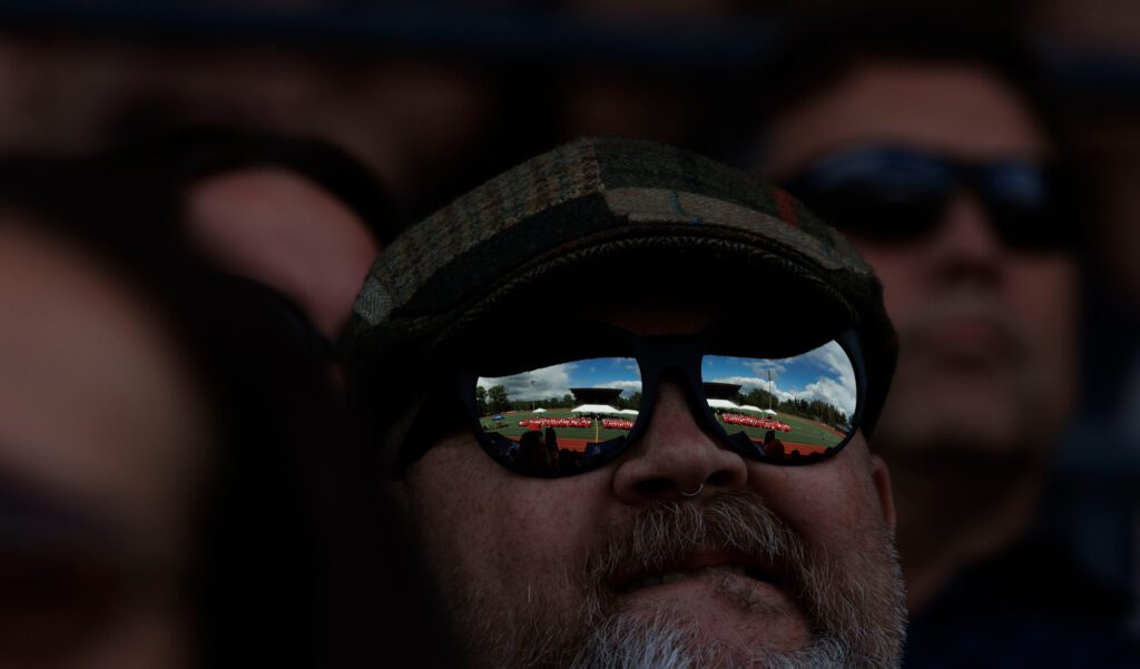 The Bellingham High School graduation ceremony is reflected in the sunglasses of an audience member.