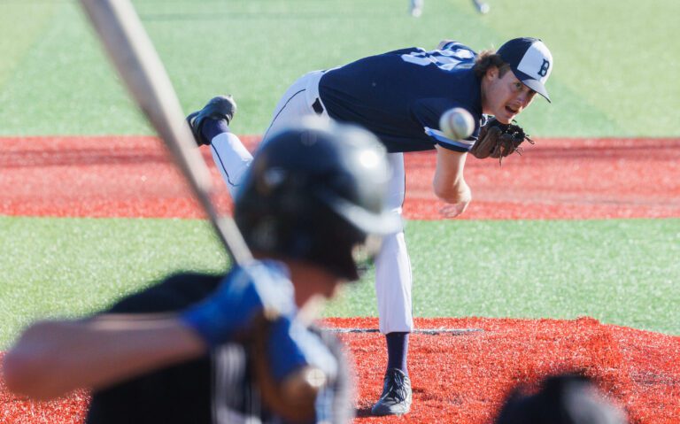 Trevin Hope throws a pitch as he keeps his eyes on the ball while a batter gets ready.